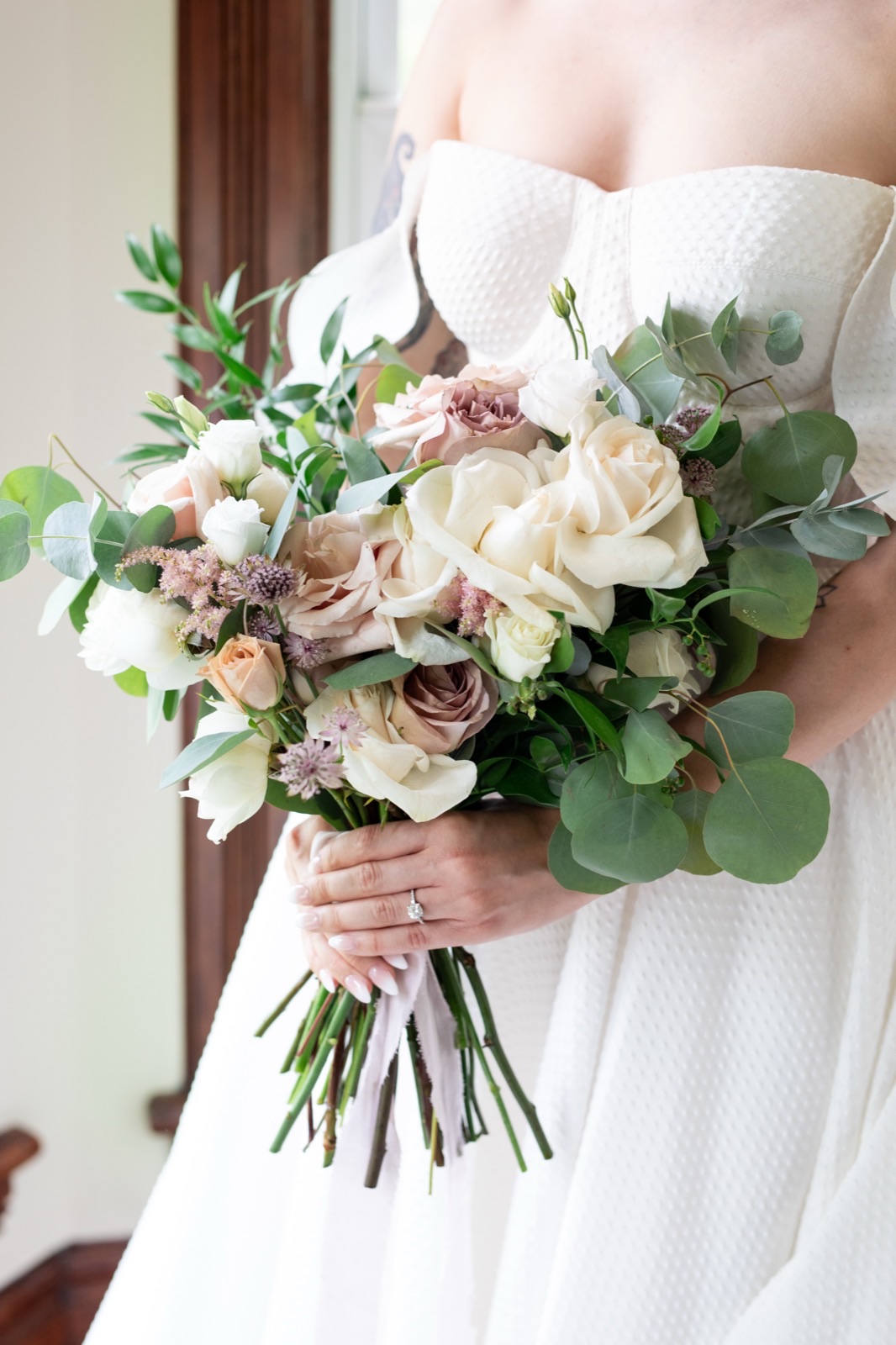 Garden-style bridal bouquet with ivory roses and eucalyptus